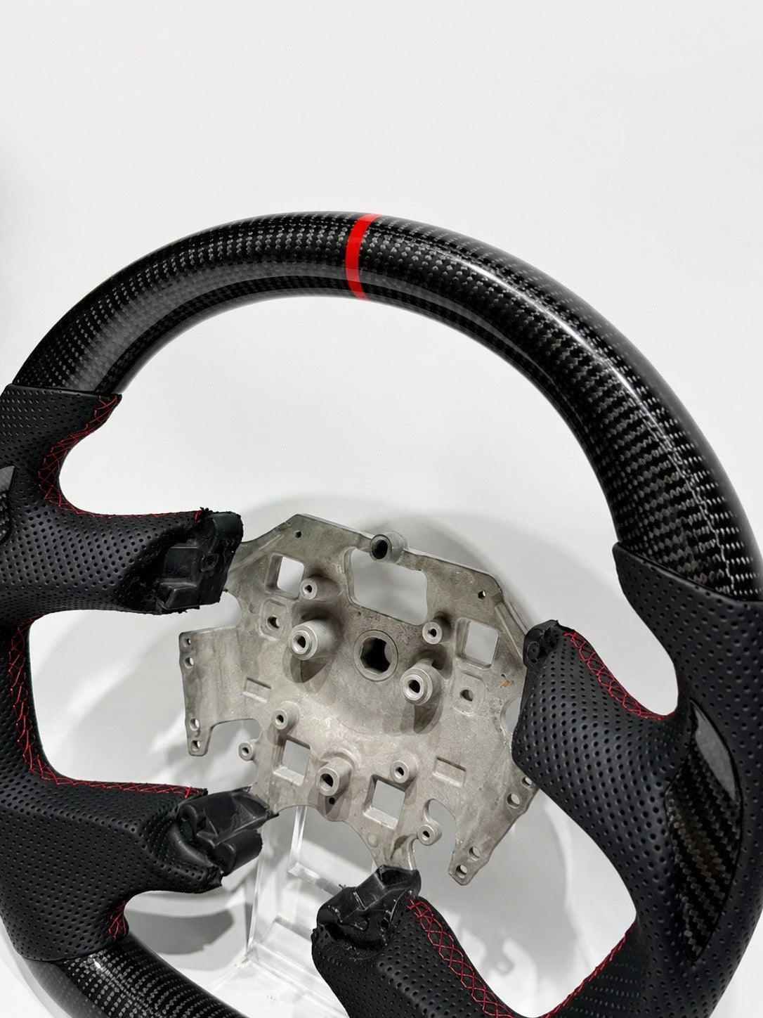 Close-up of contoured thumb grips and perforated leather on Ford Falcon FG steering wheel