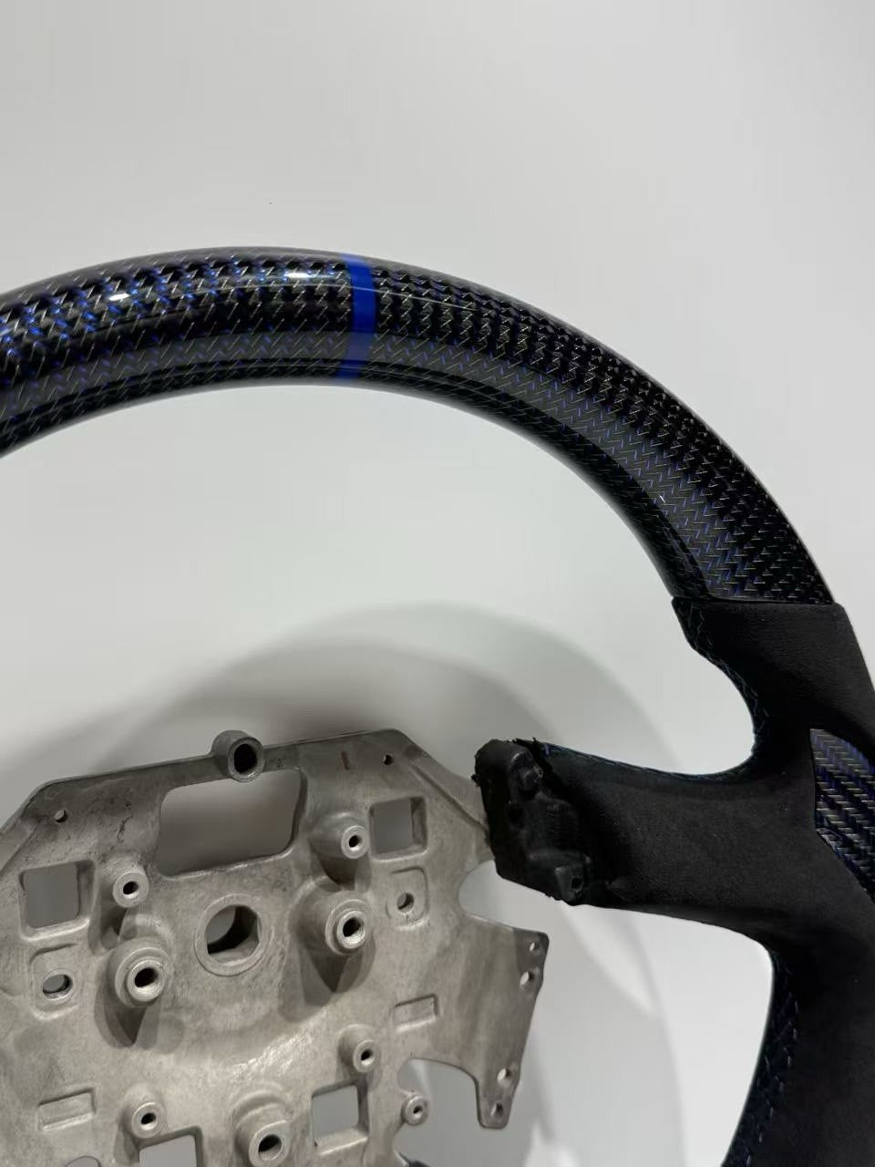 Rear of Ford Territory SZ Alcantara steering wheel showing factory control mounting points