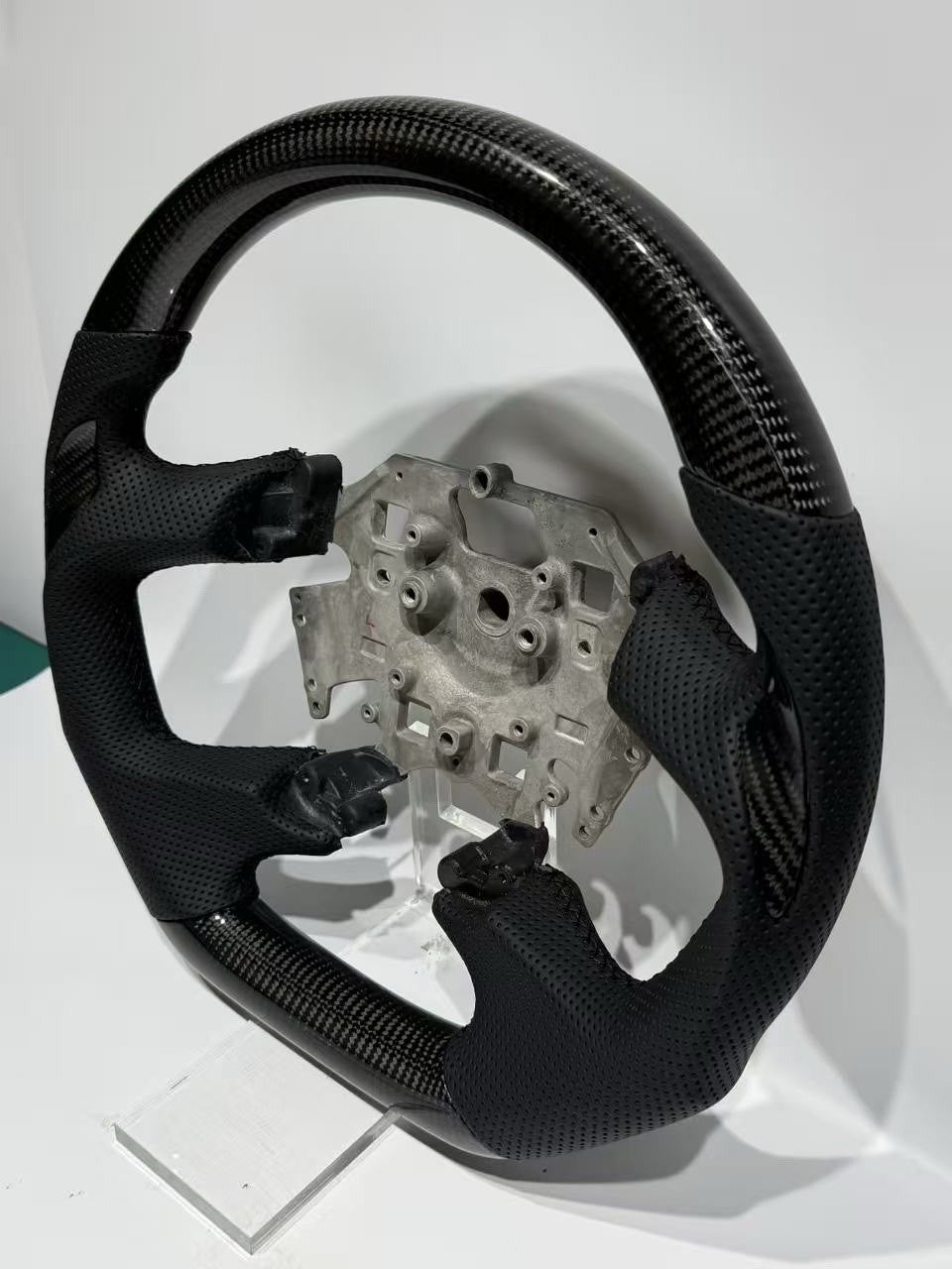 Close-up of perforated leather grip on Ford Falcon FG all black steering wheel